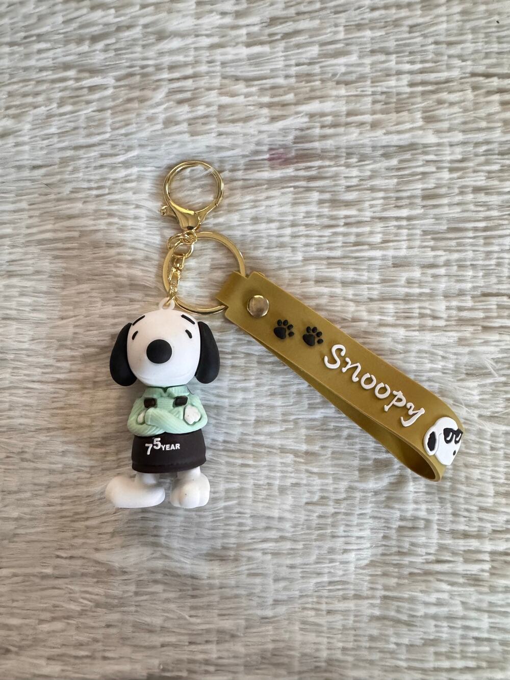 Snoopy 75th anniversary keychain with green jacket and black shorts